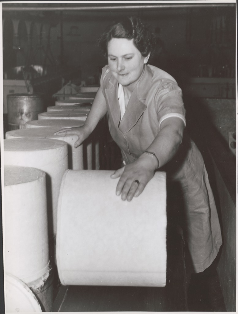 Woman working in cheese factory